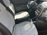 the interior of a small car with the front seats folded down