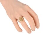 a close up of a person ' s hand with a ring on it