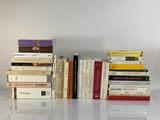 many books stacked on top of each other on a table