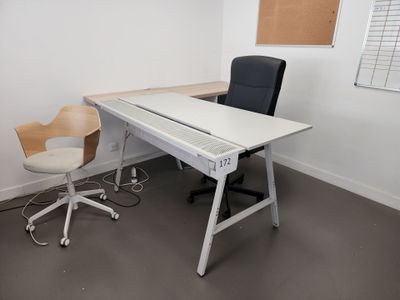 a white desk with a black chair and a brown chair