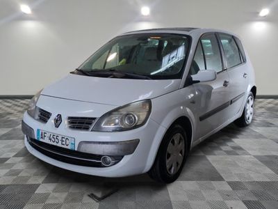 a picture of a small white car parked in a garage