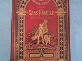 the front cover of a red book with gold trimming and a picture of an angel on it