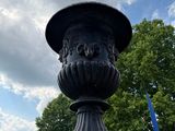 a large black urn on the side of the road