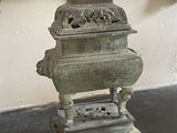 a statue of a man sitting on top of a table