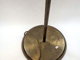 brass plated floor lamp with a metal pole and a white background