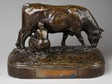 statue en bronze représentant une vache et un homme assis sur un rocher