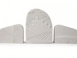 three white bookends that are sitting next to each other