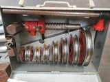 a metal box with a bunch of metal parts inside of it