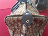 a brown and black bag with a tag on it