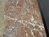 a marble table with a marble top on a tile floor