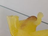 a glass table with a yellow bird on top of it