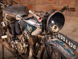 a old motorcycle that is parked in a garage