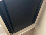 a black door in the corner of a room