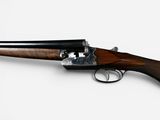 a close up of a rifle on a white surface