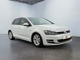 a white volkswagen golf is parked in a large room