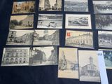 many pictures of old buildings on display on a table