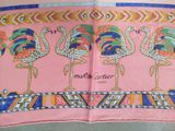 a pink scarf with a picture of a group of flamingos on it