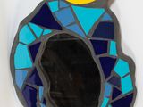 a blue and yellow mirror with a moose head on it
