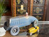 a blue toy car and a yellow toy car on a table