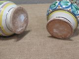 two vases that are sitting on a table