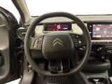 the interior of a car with a steering wheel and dashboard controls