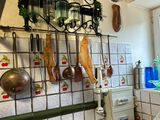 a picture of a kitchen with a lot of clutter on the wall