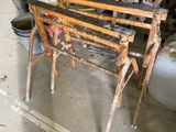 a bench made out of metal and wood in a garage