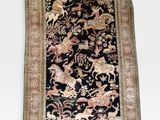 an oriental rug with animals and flowers on a black ground