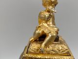 a gold figurine sitting on top of a box