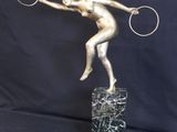 statue of a tennis player holding a racket on a marble base