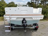 a boat that is parked on the trailer in the parking lot