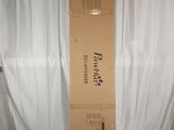 a cardboard box sitting on top of a bed in a room