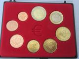 a red box with six different coins in it