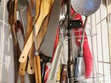 a wire basket filled with kitchen utensils and cooking utensils