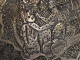 a silver plate with a picture of a man and a woman on it