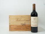 a bottle of wine sitting next to a wooden box