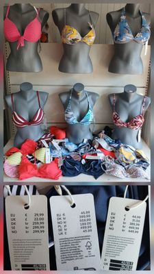 many mannequins in a store with price tags on them