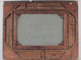 an old wooden frame with a picture hanging on the wall