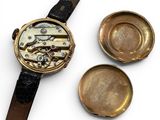 a watch and a watch case sitting next to each other on a white surface