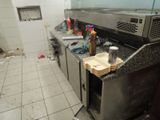 an image of a dirty kitchen with a lot of clutter on the counter