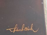 a black plate with a gold writing on it