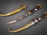 a group of three swords with gold and silver decoration