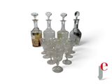 a group of wine glasses and a decanter on a table