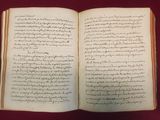 an open book with writing on it sitting on a table