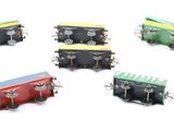 several miniature trains are arranged in a circle on a white surface