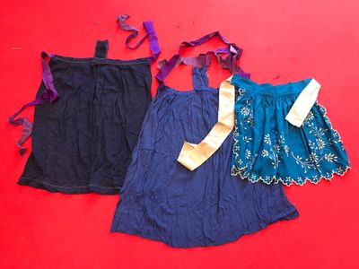 pair of blue and purple dresses on a red surface