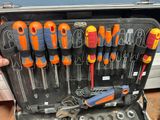 someone is holding a tool case full of various tools in it