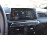 the interior of a car with a touch screen and a steering wheel