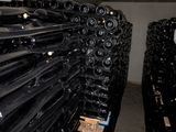many bottles of wine stacked on top of each other in a room