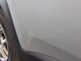 a close up of a car ' s door handle with a sticker on it